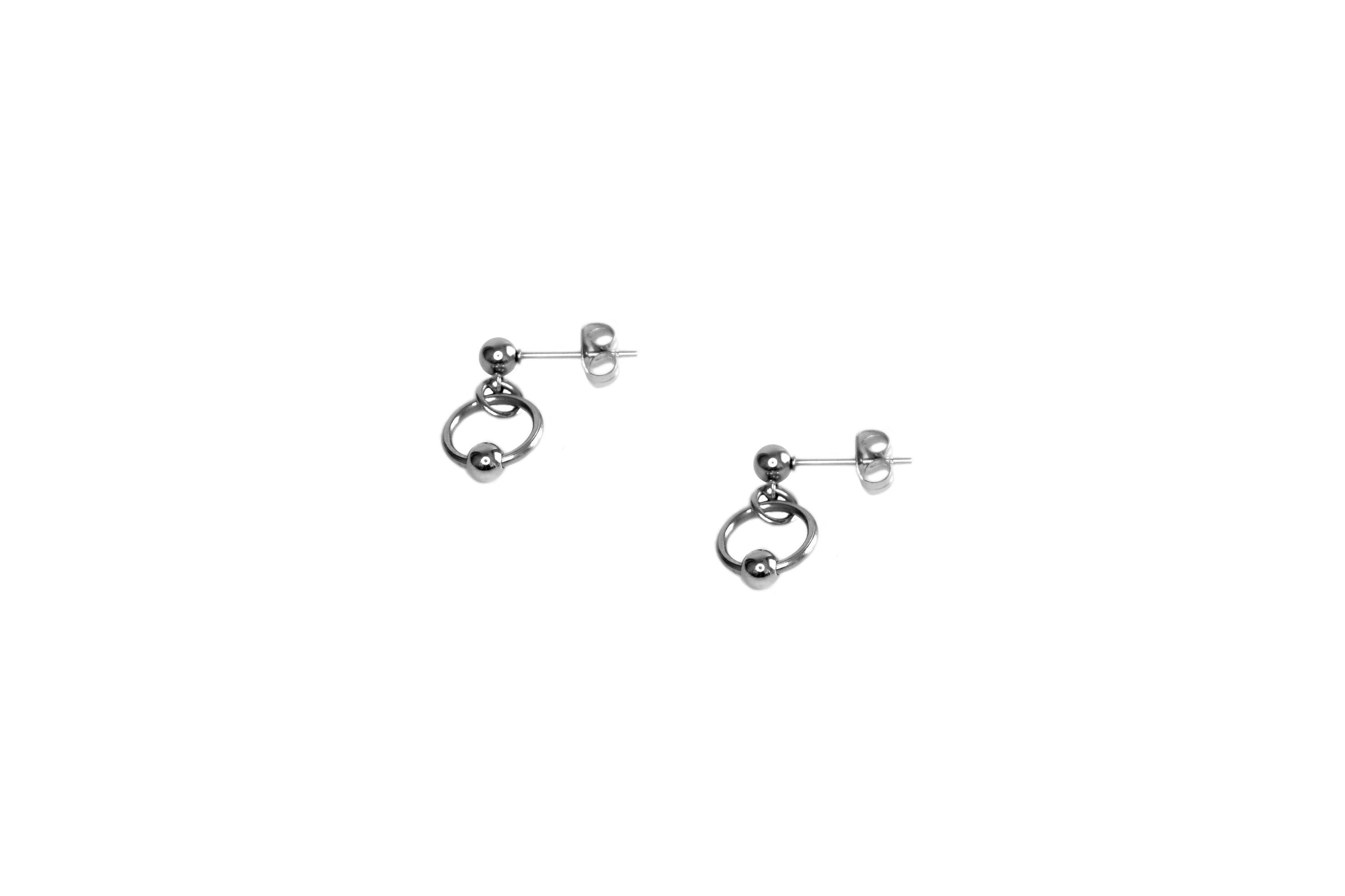 Pair of sleek mini hoop earrings by Myril Jewels, capturing the essence of neo-gothic style with a minimalist design. Ideal for those who adore the avant-garde dark aesthetic, these earrings offer a subtle yet chic statement for everyday wear, festival outings, or as a thoughtful gift for the goth girlfriend in your life.