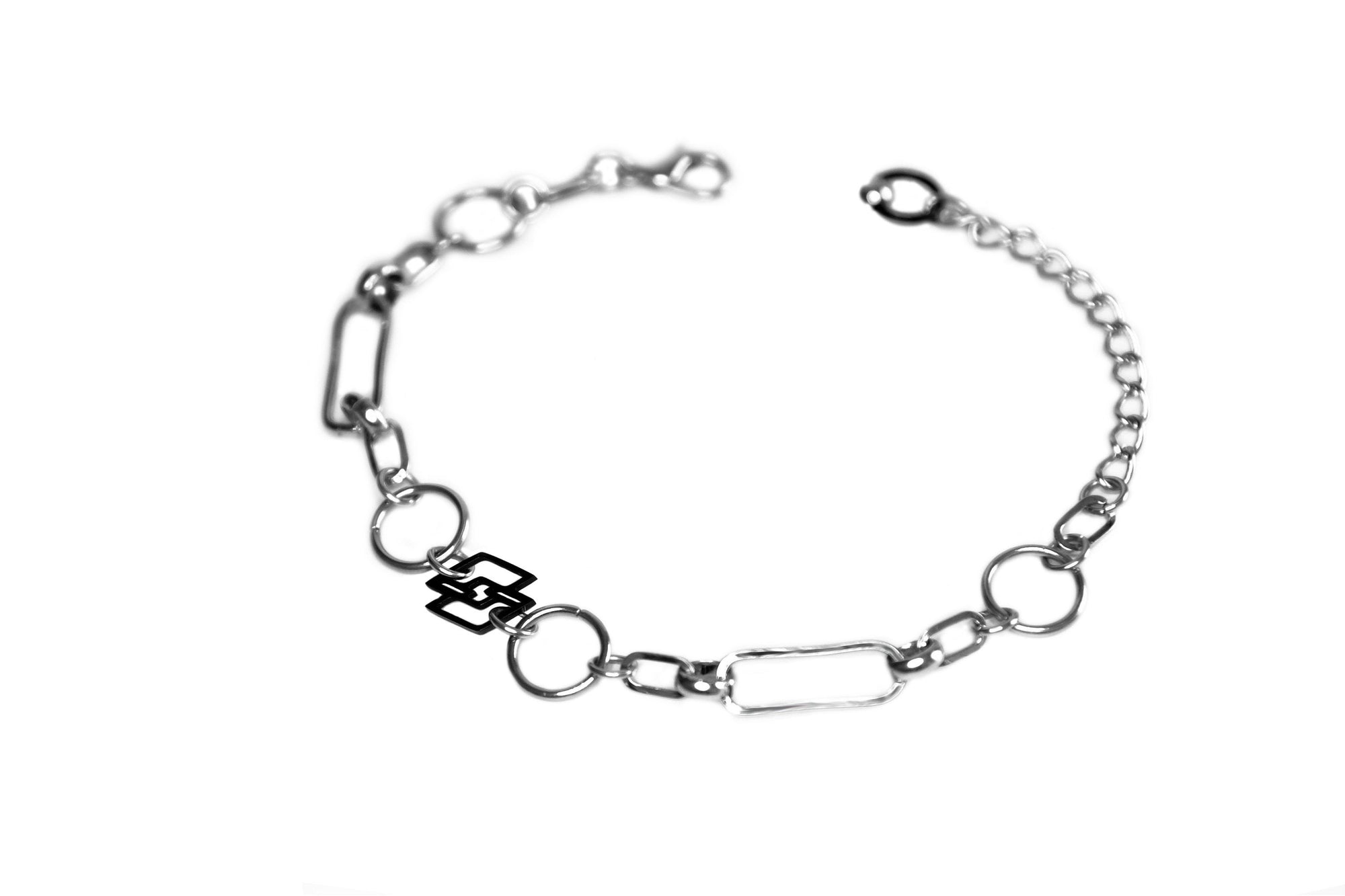 Elegant Myril Jewels chain bracelet featuring an avant-garde dark style, perfect for gothic and alternative fashion enthusiasts. This handcrafted piece from Italy blends a neo-gothic aesthetic with everyday wearability, making it a versatile accessory for both Halloween events and minimal goth daily looks. The unique design includes interlinked silver-toned chains and a distinct geometric charm, capturing the whimsigoth spirit and witchcore trends while offering a subtle punk edge