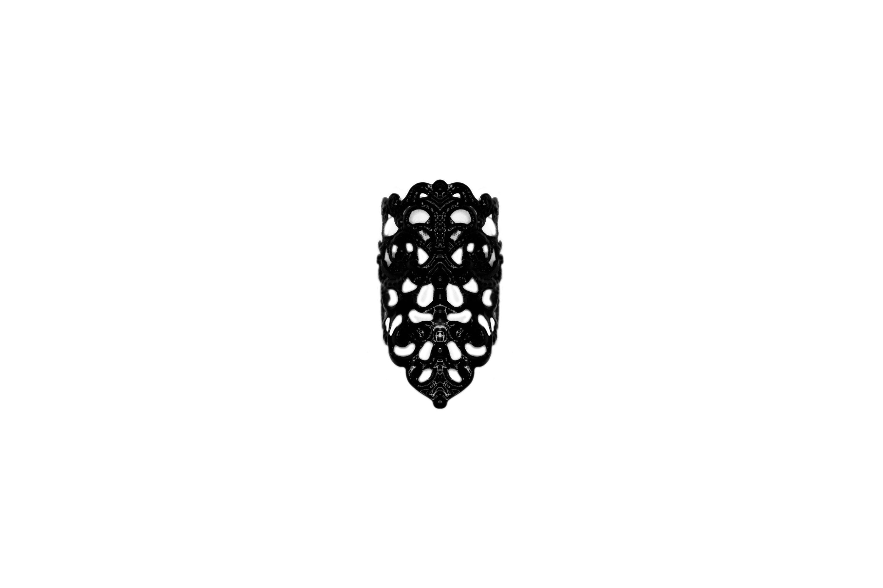 Presenting Myril Jewels' goth midi ring, a masterful expression of dark-avantgarde artistry. This neo-gothic jewel showcases an elaborate, blackened metalwork with an openwork pattern that mimics the intricate beauty of natural forms. Its bold yet intricate design captures the essence of gothic-chic, making it an ideal accessory for those drawn to the enigmatic world of whimsigoth and witchcore. Designed for everyday wear, this midi ring is also perfect for accenting Halloween costumes