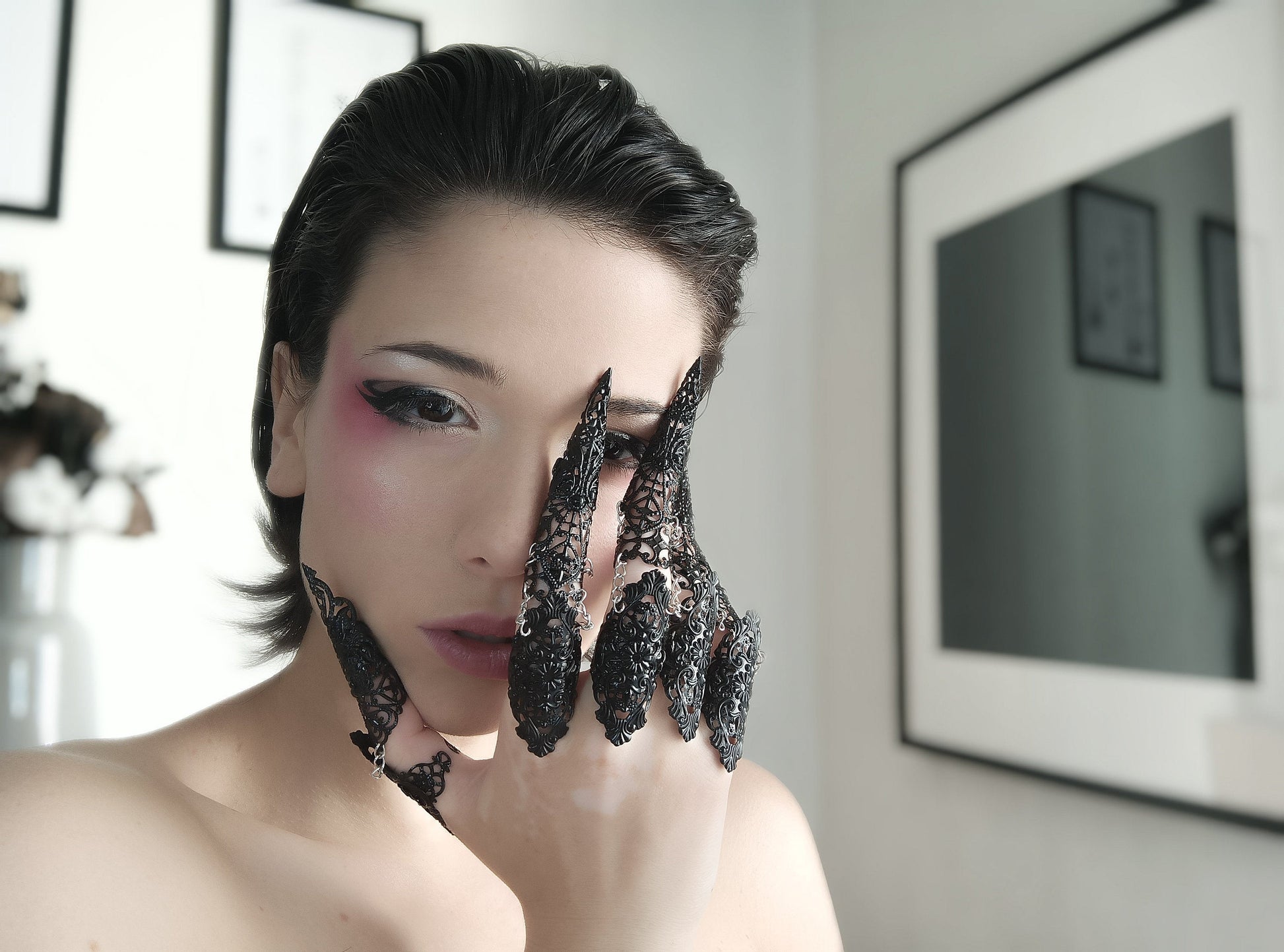 A model poses with Myril Jewels' gothic black full-finger rings, each finger adorned with an intricate, claw-like design, perfect for a bold, dark-avantgarde look